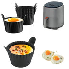 Black silicone baking cups with handles beside an air fryer