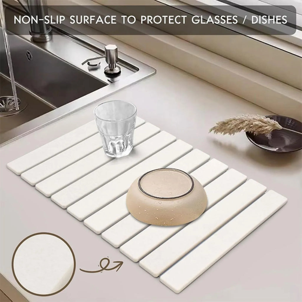 Stone dish drying mat with glasses beside a sink