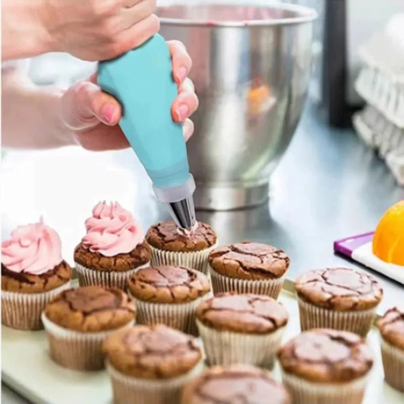 Piping icing onto cupcakes with a blue piping bag
