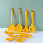 Yellow silicone cooking utensils on a blue background