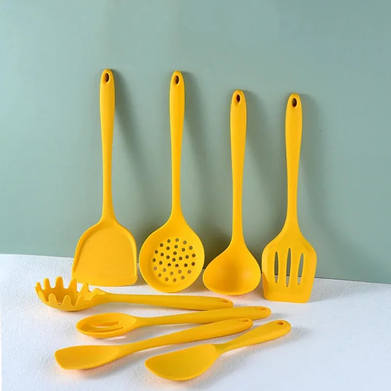 Yellow silicone cooking utensils on a blue background