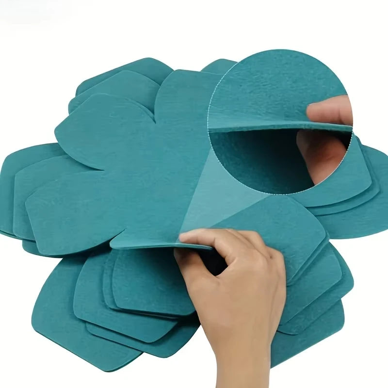 Hand placing a felt protector between stacked pans