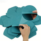 Hand placing a felt protector between stacked pans