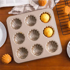 Shell-shaped cakes in a carbon steel baking pan