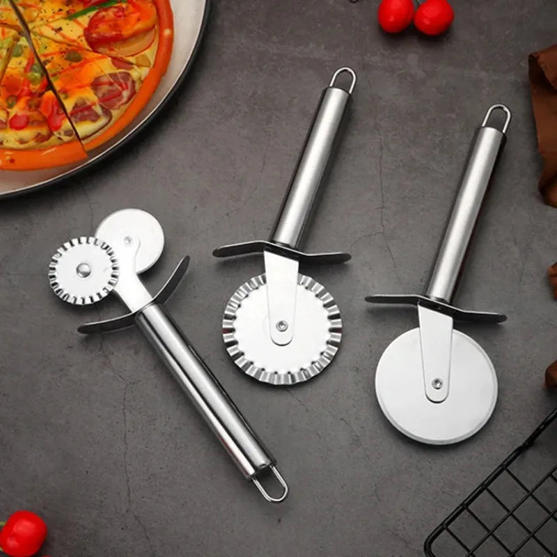 Stainless steel pizza wheels beside a pizza