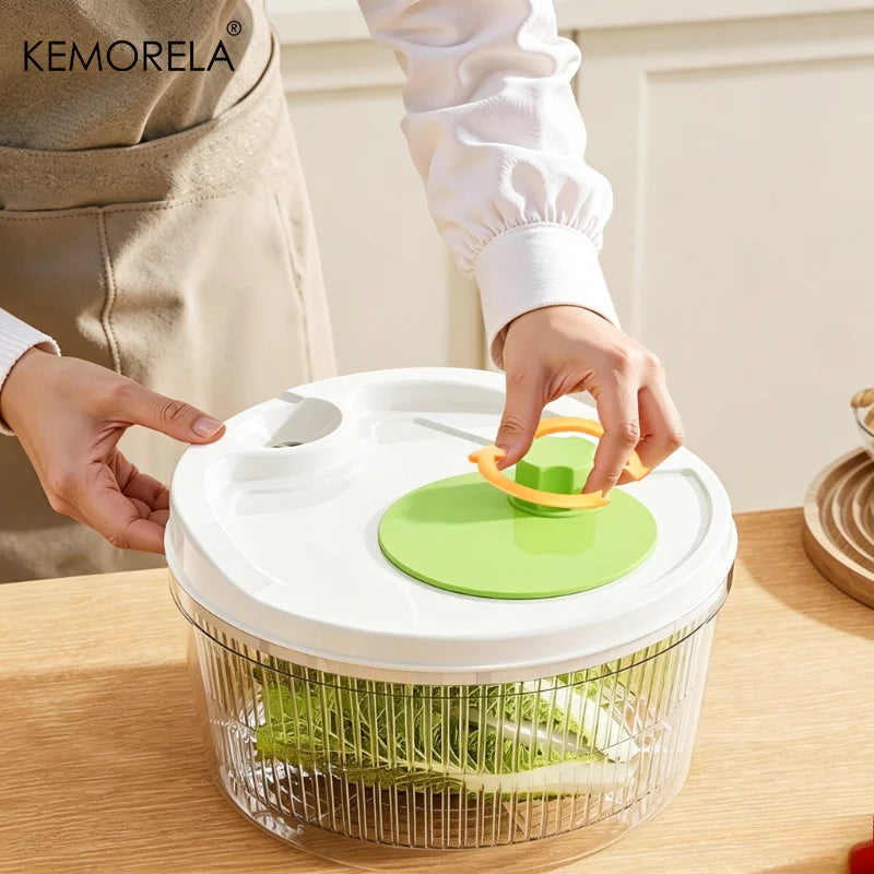 Hands using a green salad spinner