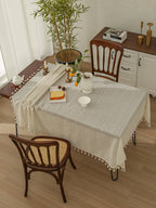 Dining table with a linen-coloured tassel edge tablecloth