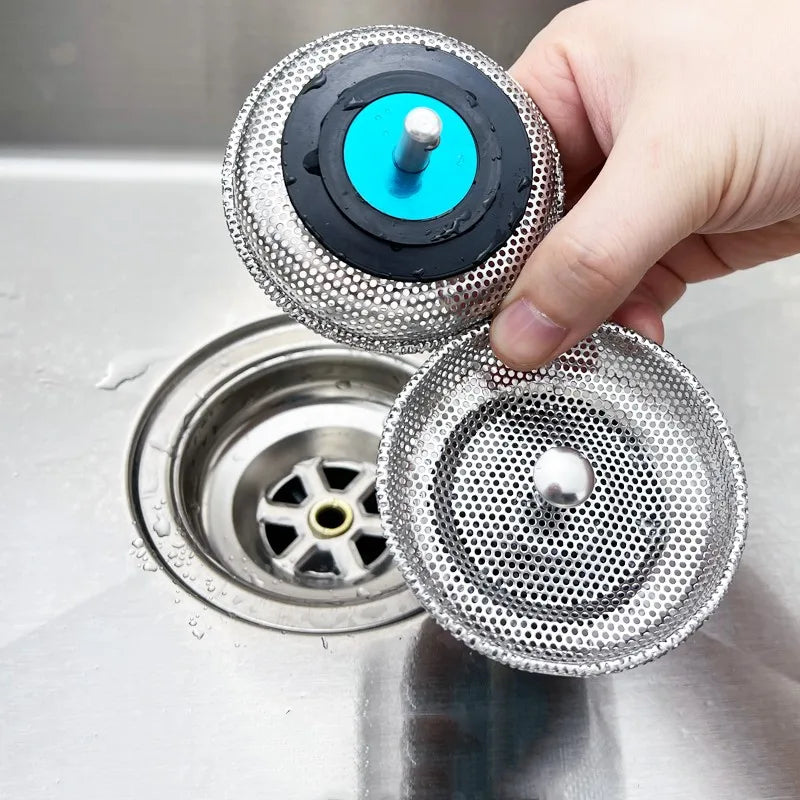 Hand lifting a mesh strainer out of a sink plughole