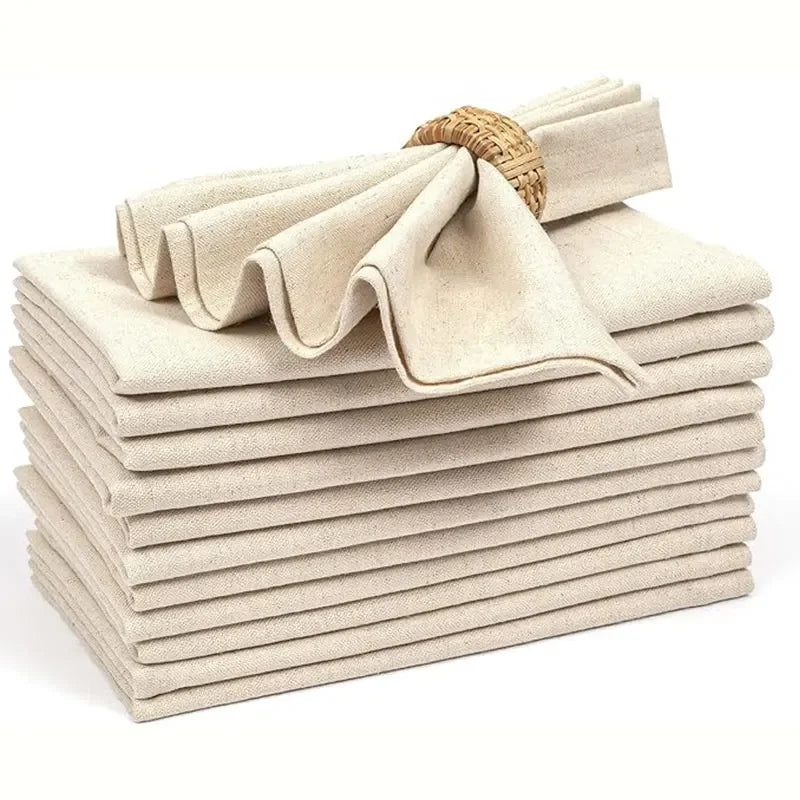 Stack of folded beige cloth napkins