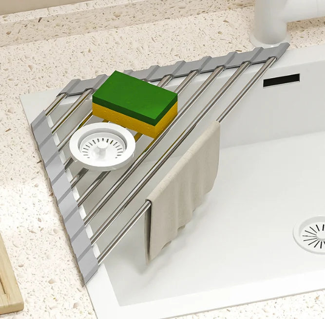 Triangular roll-up rack holding a sponge in a sink corner