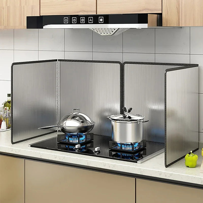 Folding stainless steel splatter guard around a gas hob