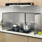Folding stainless steel splatter guard around a gas hob