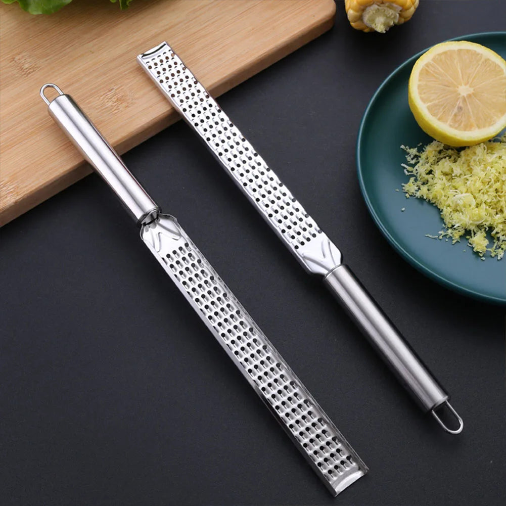 Stainless steel zester grater beside a lemon