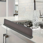 Grey silicone splash guard along the edge of a kitchen sink