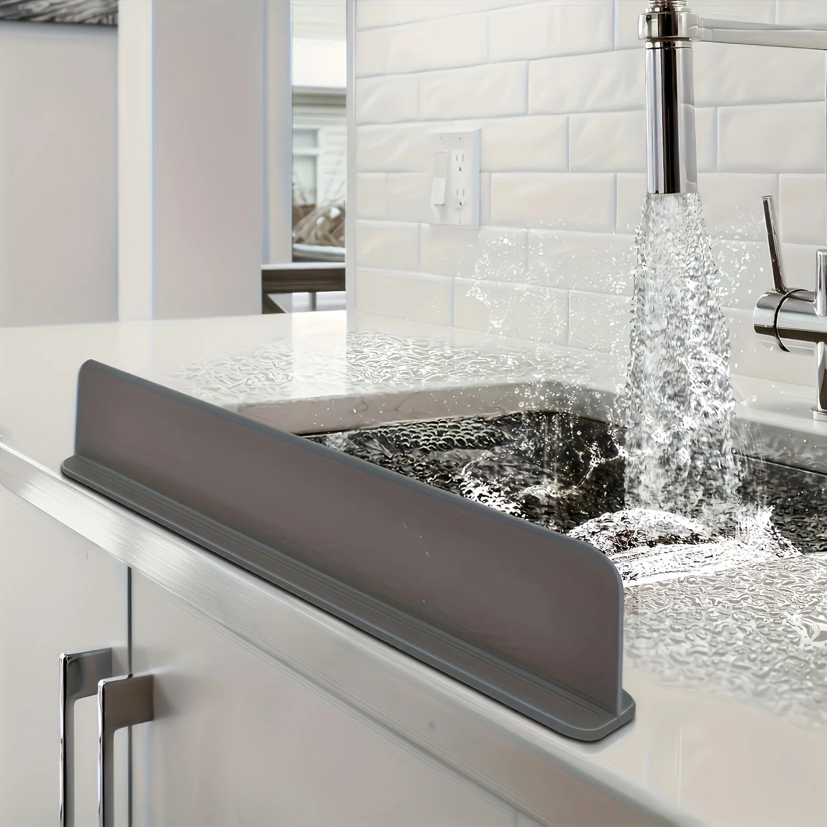 Grey silicone splash guard along the edge of a kitchen sink