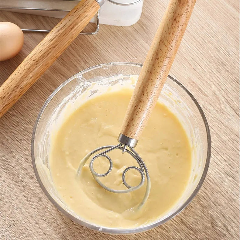 Danish dough whisk mixing batter in a glass bowl