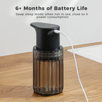 Black touchless soap dispenser on a wooden worktop