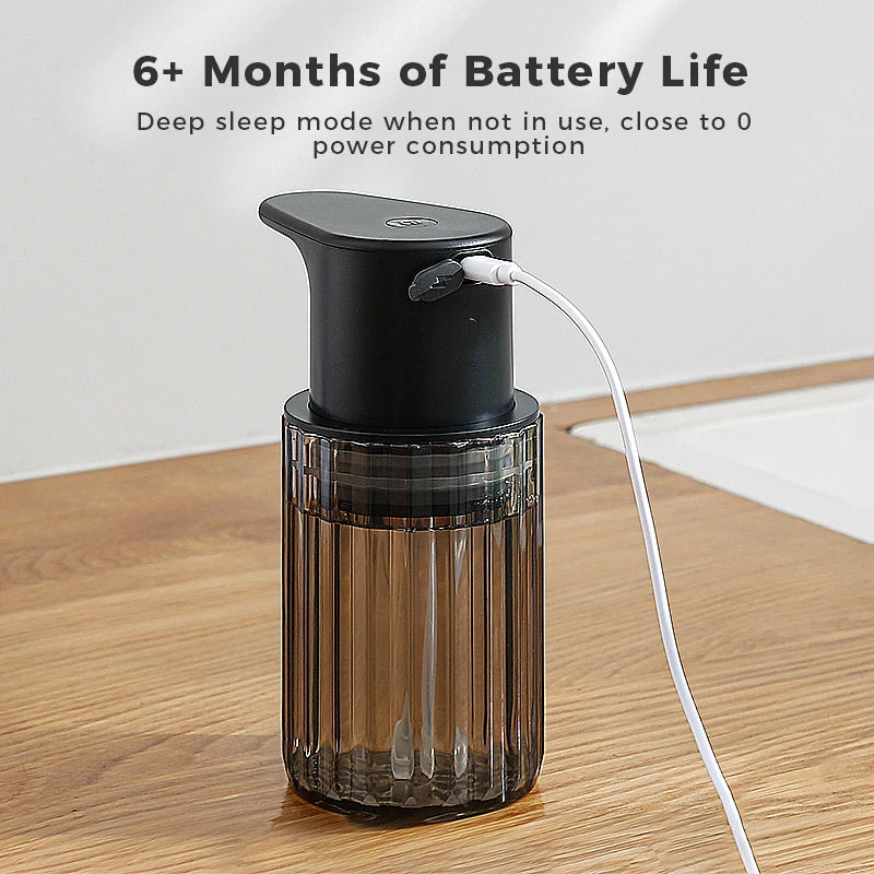 Black touchless soap dispenser on a wooden worktop