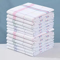 Stack of striped cotton kitchen towels in mixed colours