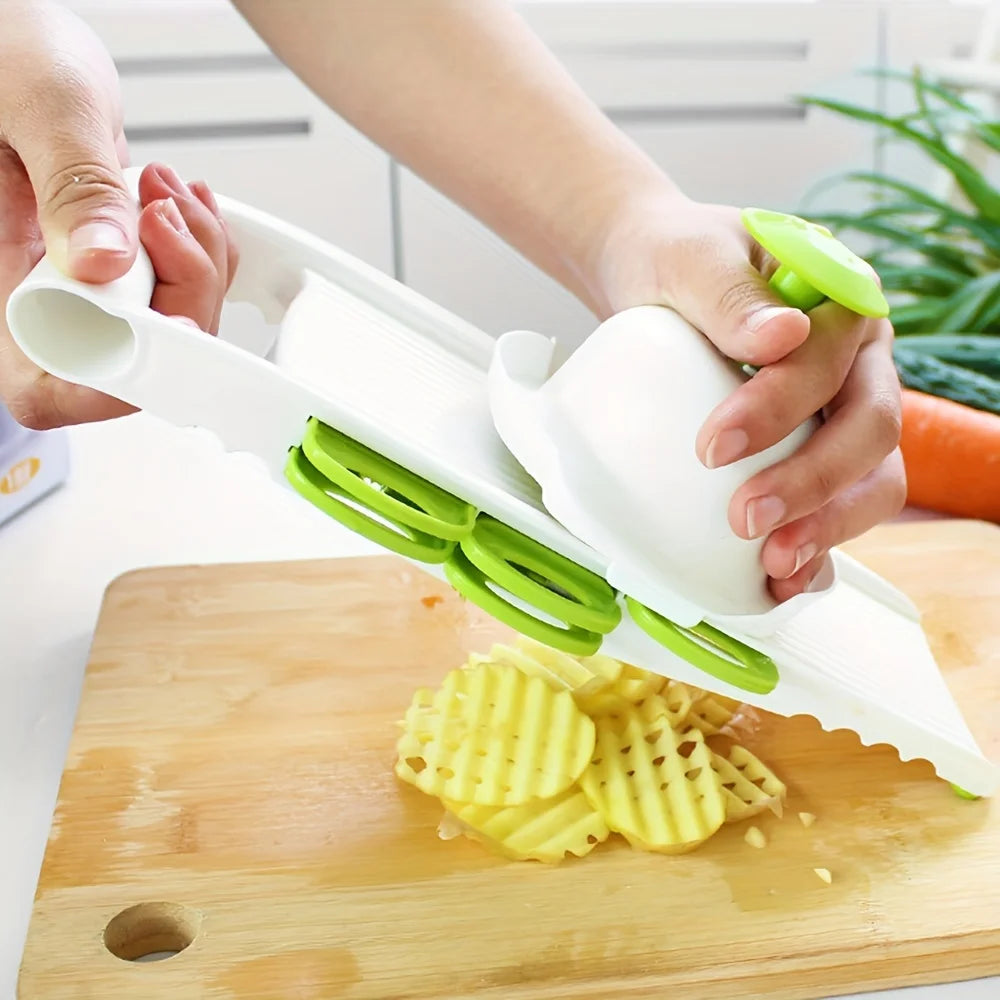 Slicing potato on a green mandoline slicer