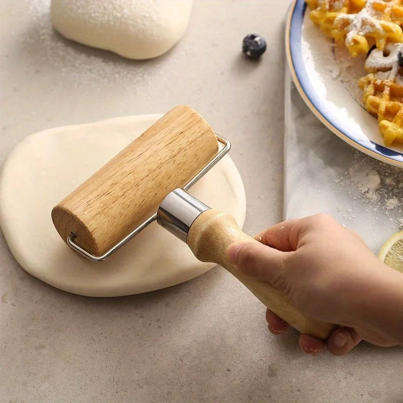 Wooden handheld pastry roller flattening dough