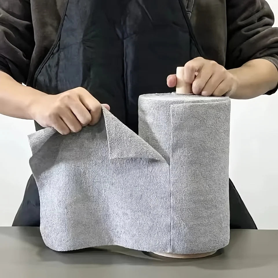 Tearing a grey microfibre cloth from a roll