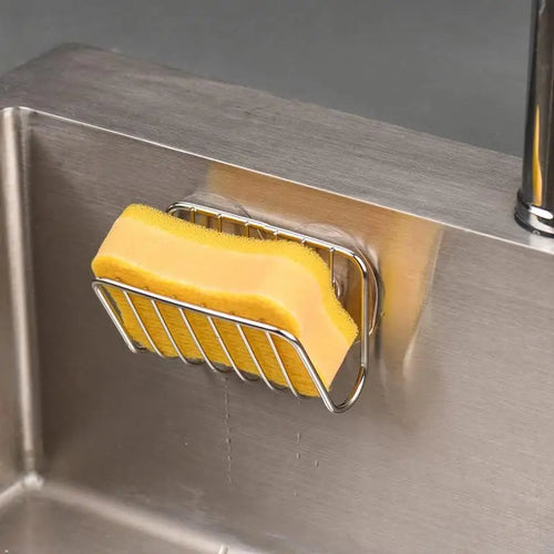 Stainless steel suction sponge holder inside a kitchen sink