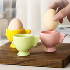 Ceramic egg cups on a wooden board