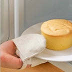 Cotton linen oven mitt holding a hot plate