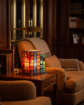 Stained Glass Book Lamp styled beside a reading armchair