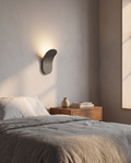 Modern Nordic wall lamp styled beside a bed