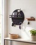 Round wooden key holder styled in an entryway
