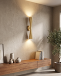 Gold wall light styled on a modern textured wall