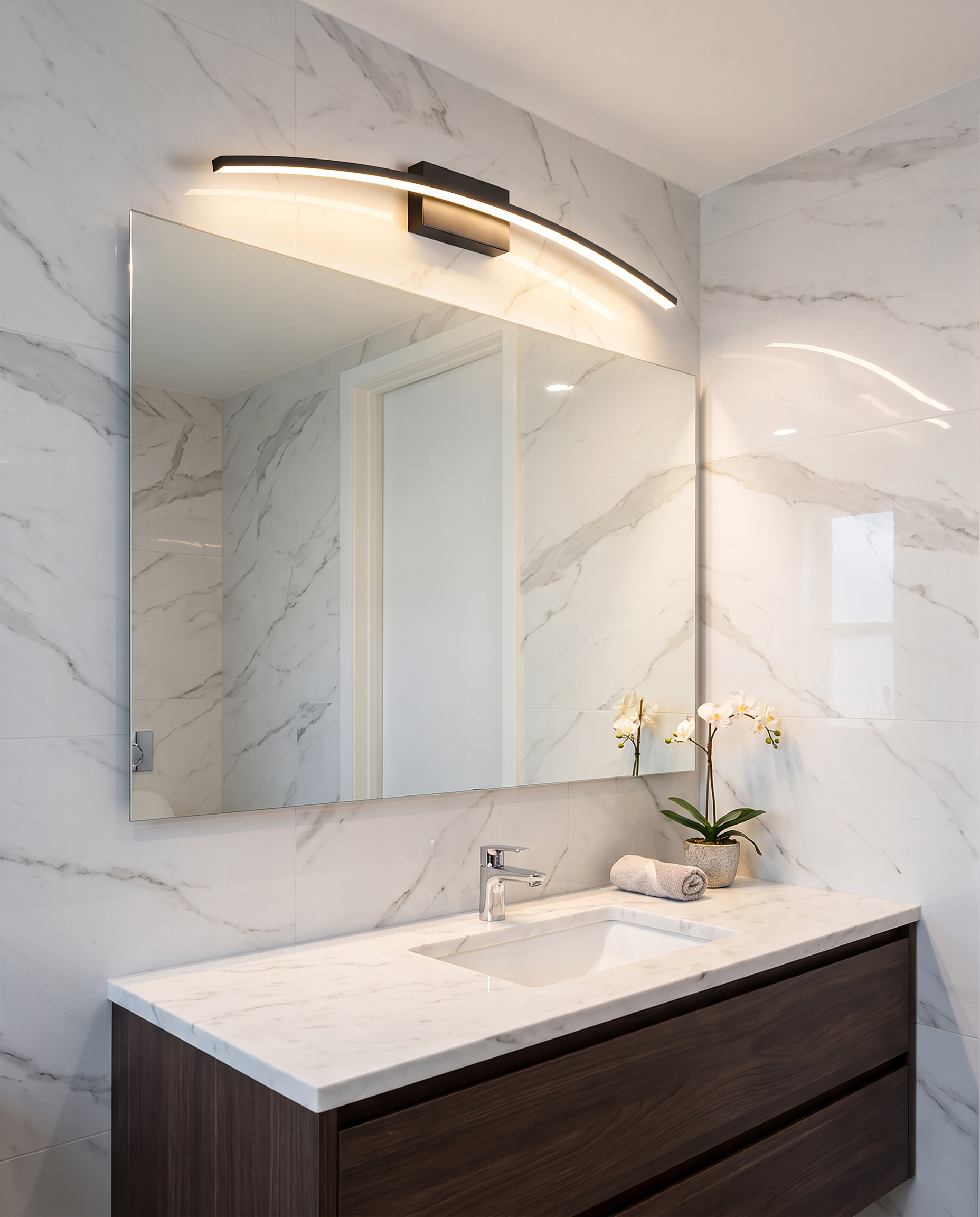 Linear LED wall sconce styled above a bathroom vanity mirror