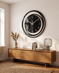 Sorana black acrylic wall clock styled above a console table