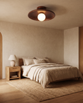 Modern wooden ceiling light styled in a warm minimalist bedroom