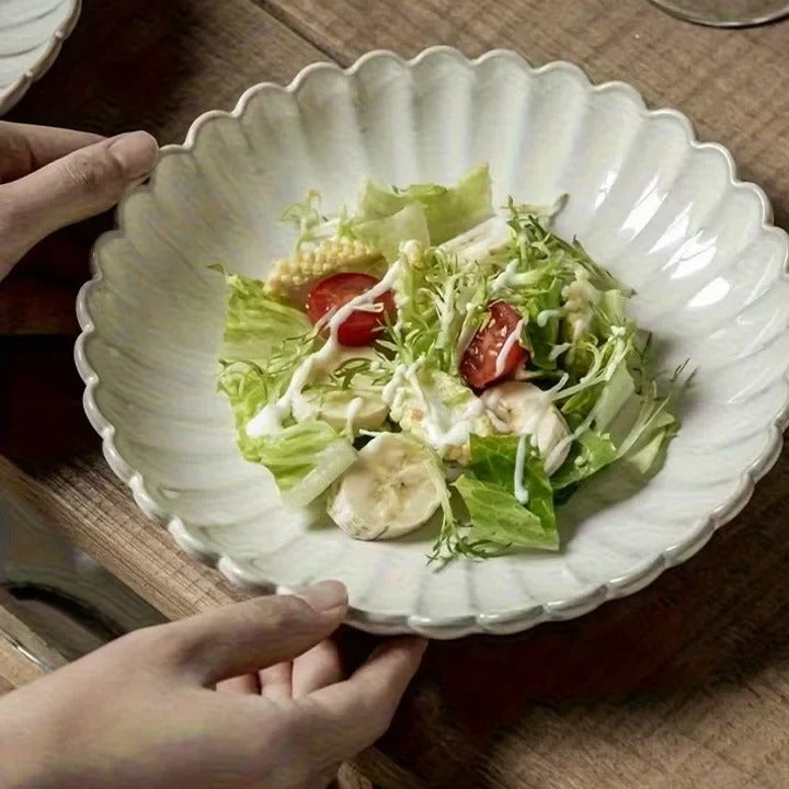 White ceramic scalloped bowl with salad