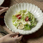 White ceramic scalloped bowl with salad